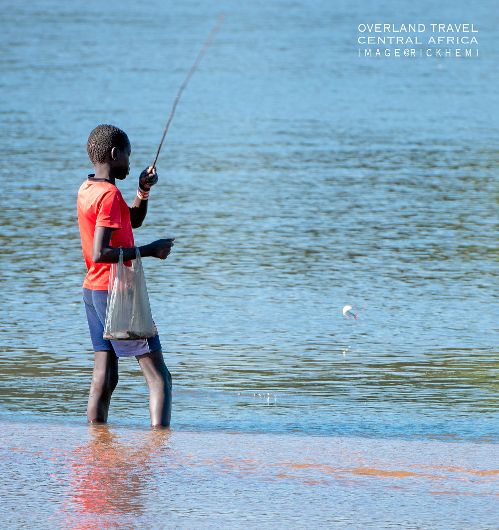 solo overland travel Africa, river fishing, image by Rick Hemi