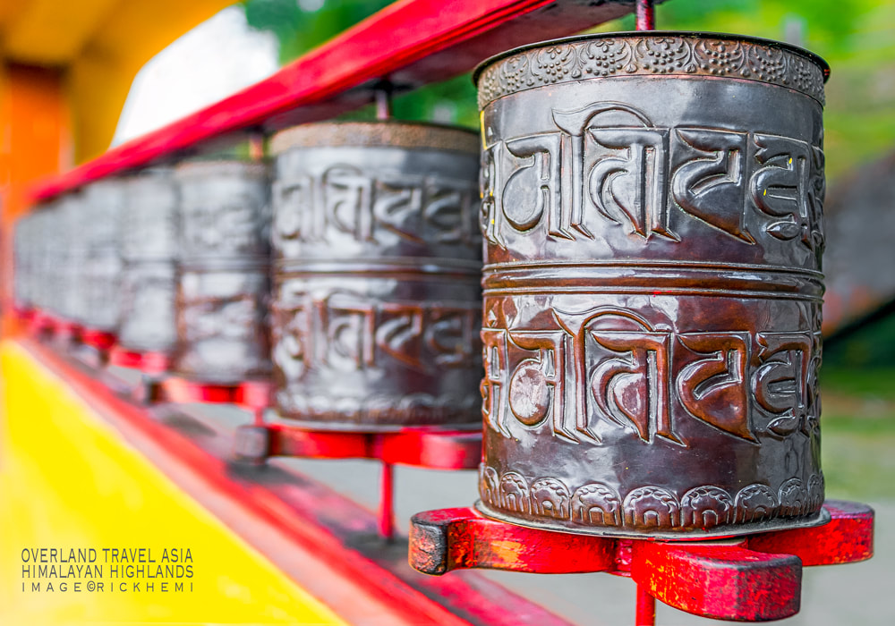 solo overland travel Asia, prayer wheels Himalayan region, image by Rick Hemi