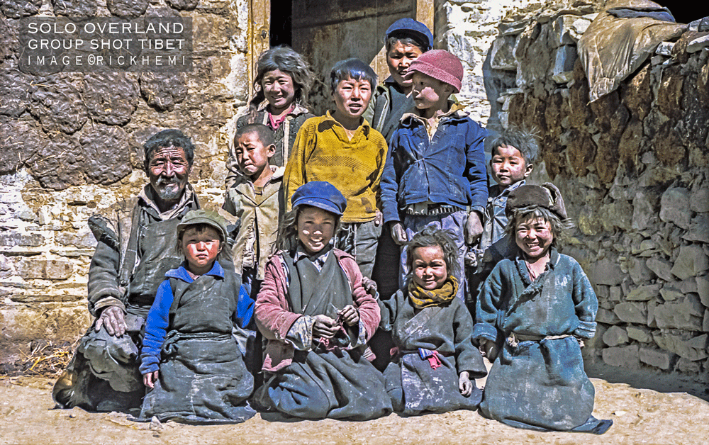 solo overland Tibet, street interaction, interacting with strangers, Asia, Africa, South America, Middle East, group shot Tibet 1980s image by Rick Hemi