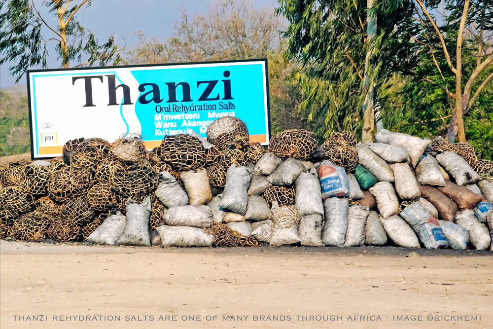 solo overland travel and transit Africa, highway Thanzi rehydration salts billboard, image by Rick Hemi