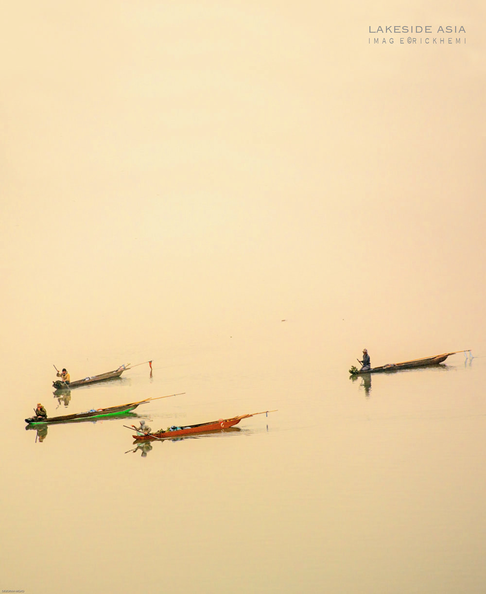 solo overland travel Asia, dugout lakeside fisherman, image by Rick Hemi 