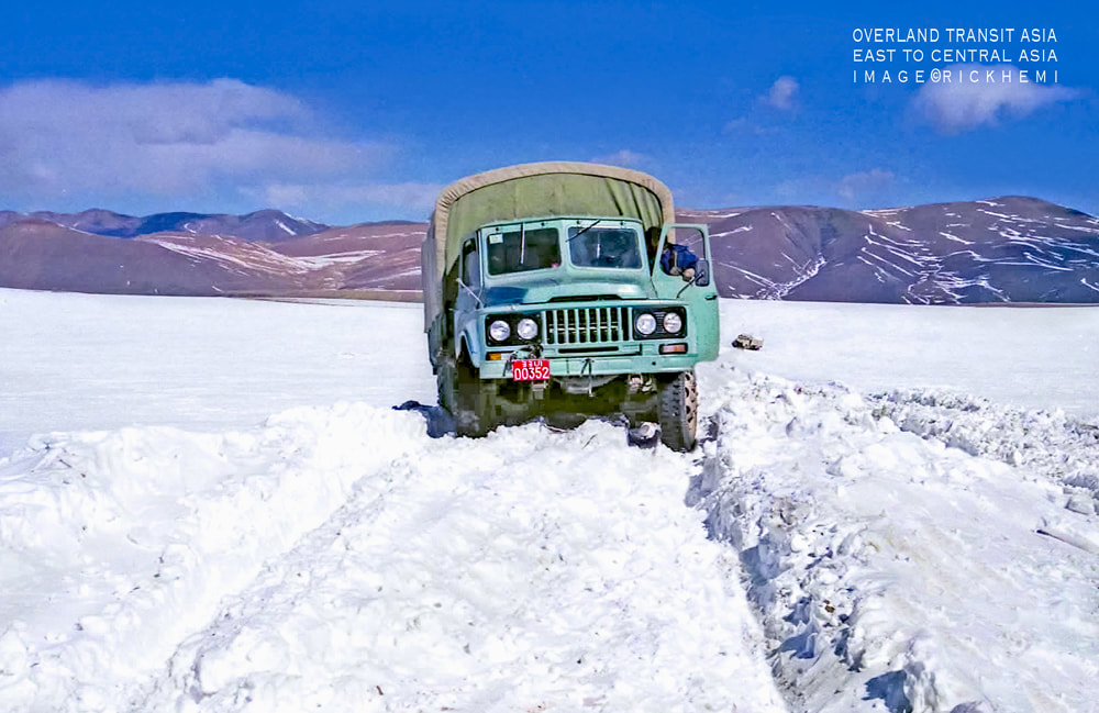 solo overland travel Asia, hitching lifts on board trucks, central Asia, midwinter hitching lifts Asia, image by Rick Hemi 