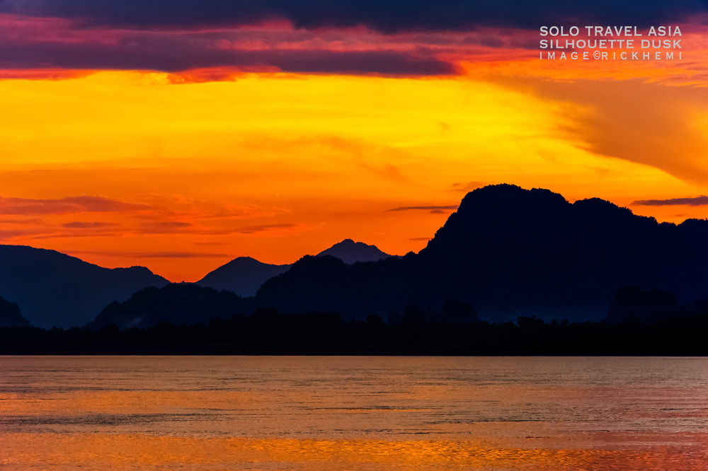 solo overland travel Asia, silhouette dusk Asia, DSLR image by Rick Hemi