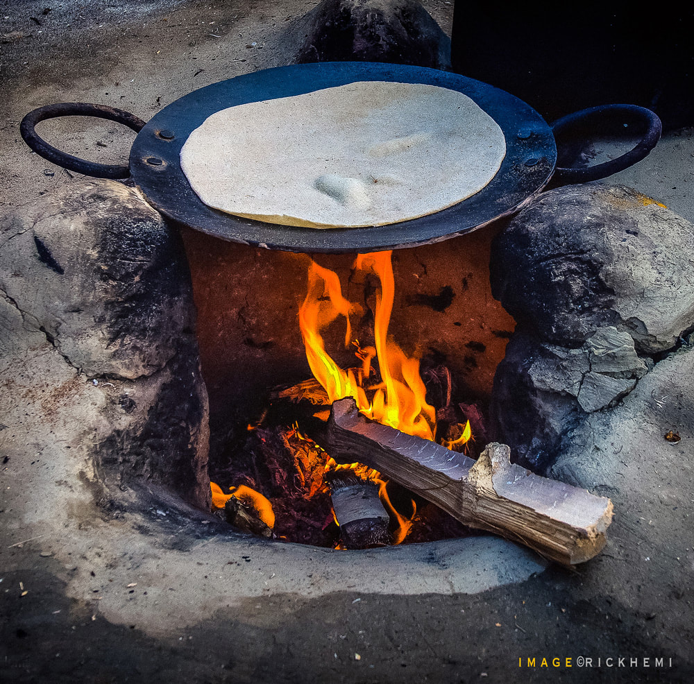 solo overland travel free camping at isolated beaches through the continents, preparing a basic open oven, Africa, Asia, South America, image by Rick Hemi