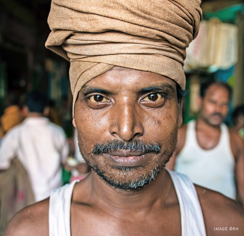 solo overland travel India, street coolie portrait, image by Rick Hemi