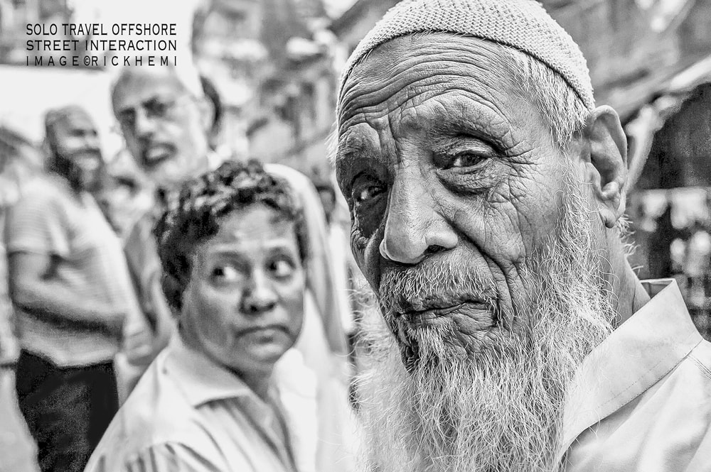 solo travel and transit offshore, interacting capturing closeup street portraits, image by Rick Hemi